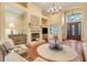 Bright living room with fireplace, chandelier, and views of the entryway at 10819 Woodchase Circle, Orlando, FL 32836