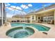 Enclosed backyard pool with spa, patio furniture, and serene landscaping at 10819 Woodchase Circle, Orlando, FL 32836