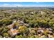 An aerial view of a house with mature trees in a serene community at 111 Autumn Dr, Longwood, FL 32779