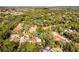 Aerial view pinpoints a home nestled in a lush neighborhood, surrounded by mature trees and well-maintained properties at 111 Autumn Dr, Longwood, FL 32779