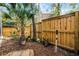 Landscaped backyard featuring a wooden fence and mature trees, offering privacy and a natural aesthetic at 111 Autumn Dr, Longwood, FL 32779