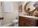 Well-lit bathroom with granite countertop and decorative oval mirror at 111 Autumn Dr, Longwood, FL 32779