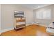 Neutral-toned bedroom featuring a dresser with television and a chair next to a window with shutters at 111 Autumn Dr, Longwood, FL 32779