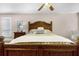 Bedroom filled with character highlighted by an eye-catching carved wooden bedframe at 111 Autumn Dr, Longwood, FL 32779