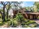 Exterior view of a well-maintained home with mature landscaping and a brick facade, blending nature and architecture at 111 Autumn Dr, Longwood, FL 32779