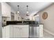 Well-lit kitchen featuring a breakfast bar with pendant lighting and granite countertops at 111 Autumn Dr, Longwood, FL 32779