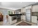 Modern kitchen with stainless steel appliances, granite countertops, and a view into the dining area at 111 Autumn Dr, Longwood, FL 32779