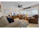 Cozy living room featuring neutral tones, a ceiling fan, and large window for natural light at 111 Autumn Dr, Longwood, FL 32779