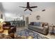 Open-concept living room with barstool seating looking into kitchen, a ceiling fan and cozy furnishings at 111 Autumn Dr, Longwood, FL 32779