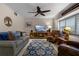 Comfortable living room showcasing neutral tones, plush seating, and natural light through plantation shutters at 111 Autumn Dr, Longwood, FL 32779