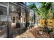 Screened patio featuring brick flooring and comfortable seating area and an exterior view of the landscaped yard at 111 Autumn Dr, Longwood, FL 32779