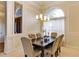 Formal dining room featuring elegant chandelier lighting, detailed trimwork, and neutral color palette at 1141 Sweet Heather Ln, Apopka, FL 32712