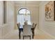 Formal dining room featuring elegant chandelier lighting, detailed trimwork, and neutral color palette at 1141 Sweet Heather Ln, Apopka, FL 32712