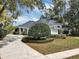 Landscaped front yard with circular driveway and well-maintained lawn at 1141 Sweet Heather Ln, Apopka, FL 32712