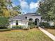 Front exterior of the home showcasing arched entryways and manicured landscaping at 1141 Sweet Heather Ln, Apopka, FL 32712