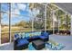 Enjoy the weather in this screened lanai with comfortable wicker seating and views of the landscaped backyard at 1141 Sweet Heather Ln, Apopka, FL 32712