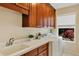 Well-lit laundry room with ample counter space, a sink, and a window at 1141 Sweet Heather Ln, Apopka, FL 32712