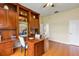 Hardwood floor office featuring built-in shelving, desk, and view to an adjacent carpeted room at 1141 Sweet Heather Ln, Apopka, FL 32712