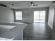 Bright living room with vinyl flooring, modern ceiling fans, and a view of the screened lanai at 11500 Brandiwine Ct, Clermont, FL 34711