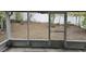 Enclosed screened porch, offering outdoor living space, overlooking the backyard's mature landscaping at 11500 Brandiwine Ct, Clermont, FL 34711