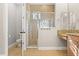 Bathroom with glass-enclosed shower, vanity, and toilet behind an open door at 11521 Camden Park Dr, Windermere, FL 34786