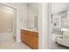 Bathroom with a double sink vanity and a tiled tub/shower combo, and doorway to a bedroom at 11521 Camden Park Dr, Windermere, FL 34786