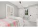 Bedroom with modern window shutters and gray walls, creating a cozy and private space at 11521 Camden Park Dr, Windermere, FL 34786