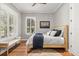 This bedroom features hardwood floors, natural light, and neutral paint at 11521 Camden Park Dr, Windermere, FL 34786