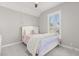 Bedroom with white-trimmed window and a bed with pastel bedding at 11521 Camden Park Dr, Windermere, FL 34786