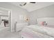 Bedroom with light walls, white dresser, a cozy bed, and a view into the hall at 11521 Camden Park Dr, Windermere, FL 34786