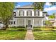 Charming two-story home featuring a welcoming front porch and professionally landscaped front yard at 11521 Camden Park Dr, Windermere, FL 34786