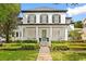 Charming two-story home with black shutters, a front porch, and meticulously landscaped front yard at 11521 Camden Park Dr, Windermere, FL 34786