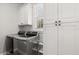 Functional laundry room with stainless steel washer and dryer, white cabinets, and natural light at 11521 Camden Park Dr, Windermere, FL 34786