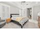 Comfortable main bedroom featuring a tray ceiling, neutral tones, and a door to the en-suite bathroom at 11521 Camden Park Dr, Windermere, FL 34786