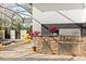 Outdoor kitchen with built-in grill, sink, and granite countertop overlooking the pool at 11521 Camden Park Dr, Windermere, FL 34786