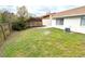 Backyard view showcasing green grass, partial fencing, and an AC unit at 142 Long Leaf Pine Cir, Sanford, FL 32773