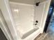 Bathroom bathtub features shower head, integrated shelving and black fixtures, offering style and practicality at 142 Long Leaf Pine Cir, Sanford, FL 32773