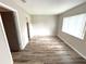 Bedroom with wood-look floors, neutral walls, a window and 2 doorways at 142 Long Leaf Pine Cir, Sanford, FL 32773