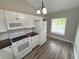 Well-lit kitchen featuring white appliances and ample storage at 142 Long Leaf Pine Cir, Sanford, FL 32773