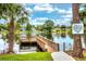 A serene lake view featuring a wooden dock, clear water, and a catch-and-release sign at 142 Long Leaf Pine Cir, Sanford, FL 32773