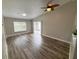 Bright living room with vaulted ceiling, ceiling fan, and sliding glass doors at 142 Long Leaf Pine Cir, Sanford, FL 32773