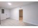 A light grey room with a white door and trim and light wood colored flooring at 1497 Jay St, Longwood, FL 32750