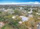 Panoramic aerial view of the property, highlighting the metal roof and neighborhood with mature trees and waterways at 1510 Live Oak St, New Smyrna Beach, FL 32168