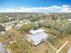 Aerial view of home with grey roof, showcasing the front yard and neighborhood at 1510 Live Oak St, New Smyrna Beach, FL 32168