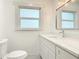 Updated bathroom featuring a modern vanity, stylish mirror, and charming patterned tile flooring at 1510 Live Oak St, New Smyrna Beach, FL 32168