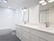 Modern bathroom featuring double sinks, white cabinets, and a black and white tiled floor at 1510 Live Oak St, New Smyrna Beach, FL 32168