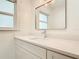 Modern bathroom featuring a sleek vanity with quartz countertop, framed mirror, and updated fixtures at 1510 Live Oak St, New Smyrna Beach, FL 32168