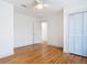 Bedroom featuring hardwood floors, a ceiling fan, and a closet with white shutter doors at 1510 Live Oak St, New Smyrna Beach, FL 32168