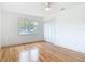 Bedroom featuring hardwood floors, a ceiling fan and a closet with white shutter doors at 1510 Live Oak St, New Smyrna Beach, FL 32168