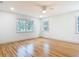 Bedroom featuring hardwood floors and natural light from windows at 1510 Live Oak St, New Smyrna Beach, FL 32168